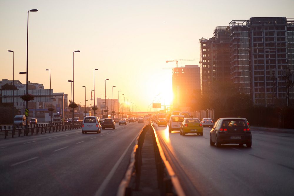Cars on a highway during golden hour. Original public domain image from Wikimedia Commons