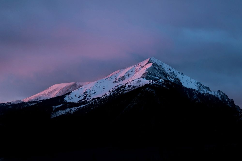 A sharp snow-capped mountain peak in Silverthorne during dusk. Original public domain image from Wikimedia Commons