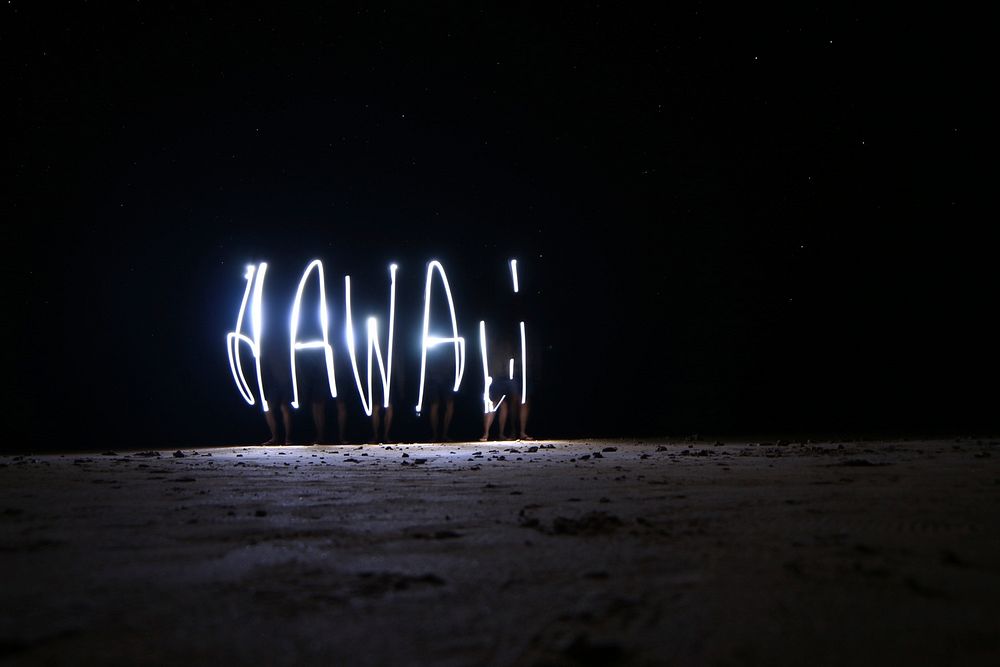 A night-time light painting that spells out HAWAII, taken on Anini Beach. Original public domain image from Wikimedia Commons