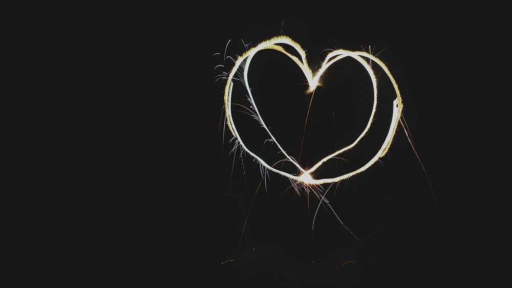 A heart-shaped sparkler against a black background. Original public domain image from Wikimedia Commons