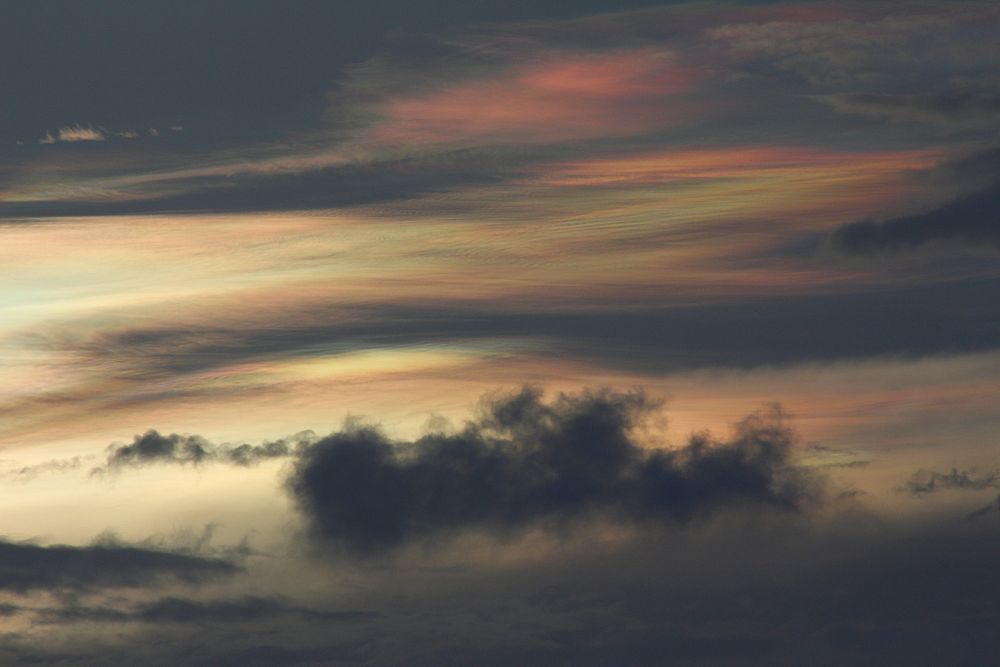 Twilight sky casted in dark gold and black colored clouds and atmosphere. Original public domain image from Wikimedia Commons