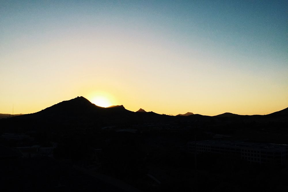 Silhouette of San Luis Obispo mountain range with yellow dawn-or-dusk sky. Original public domain image from Wikimedia…