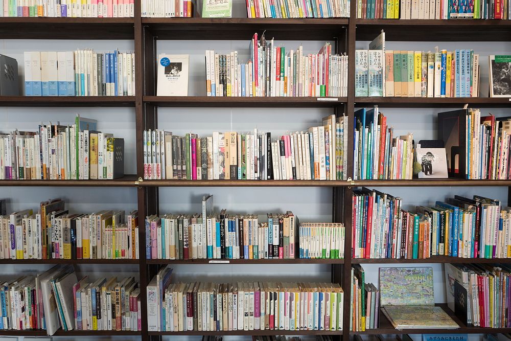A bookshelf with lots of colored books. Original public domain image from Wikimedia Commons
