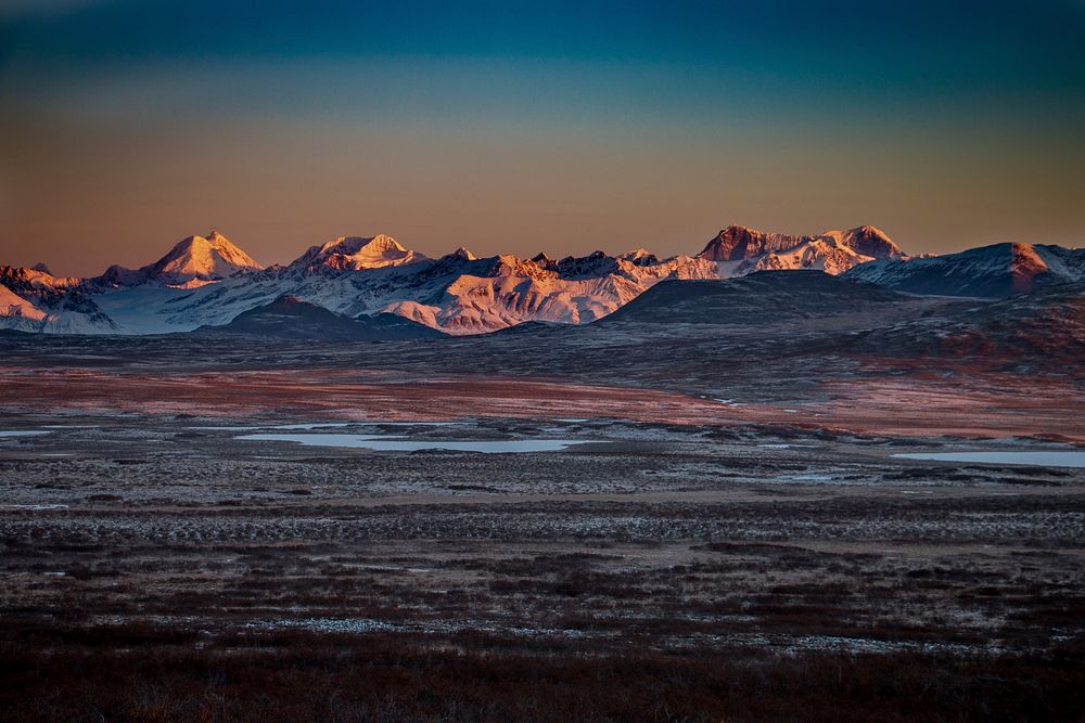 Frozen tundra near the mountains during sunset. Original public domain image from Wikimedia Commons