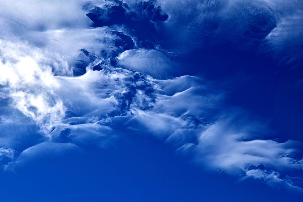 Clouds on a bright blue sky. Original public domain image from Wikimedia Commons