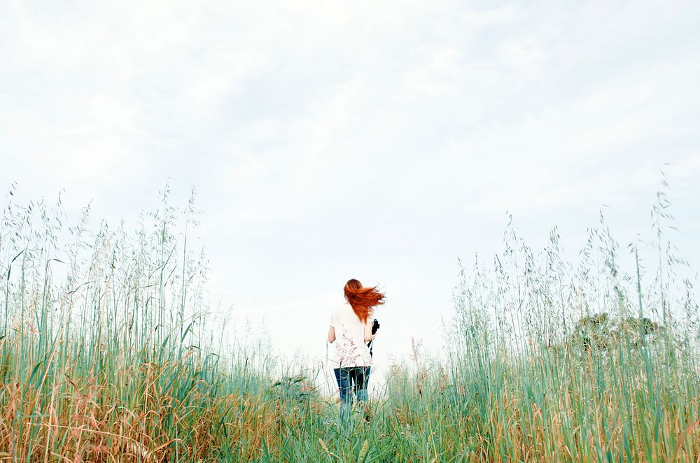 Woman standing in a flower field. Original public domain image from Wikimedia Commons