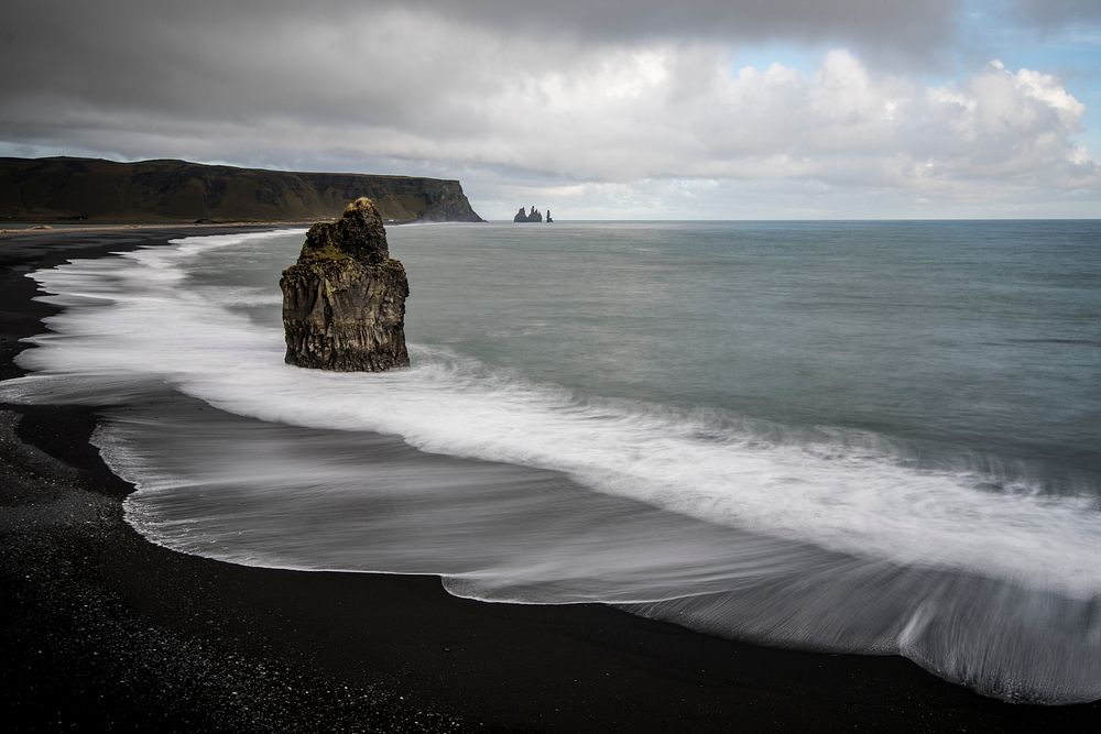 Large rock on the black sand beach in Vik, Iceland. Original public domain image from Wikimedia Commons