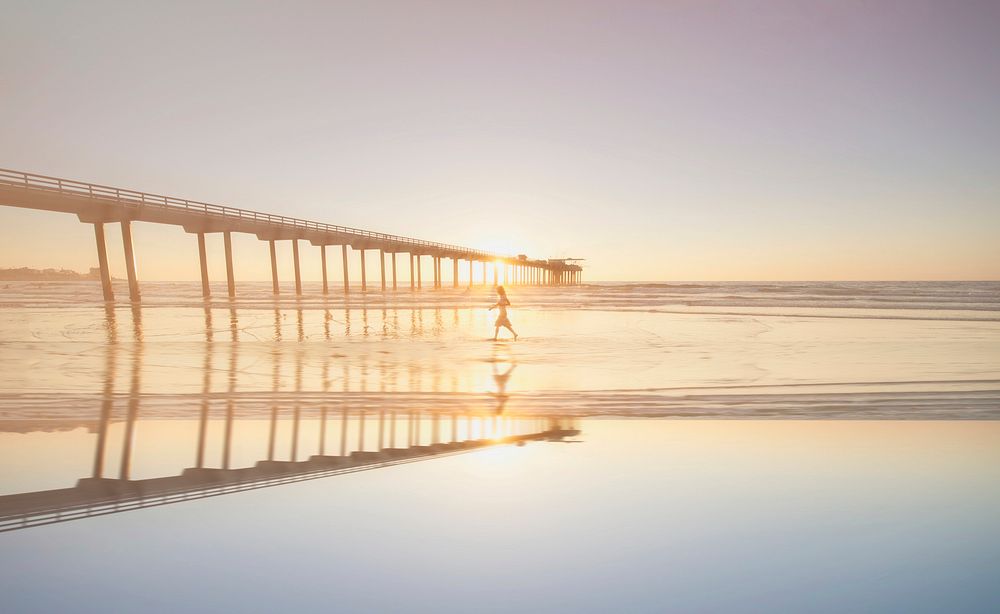 Woman walking on a beach in San Diego, United States. Original public domain image from Wikimedia Commons