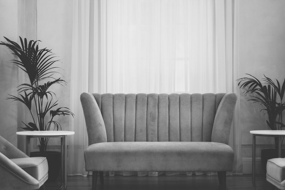 A grayscale vintage style living room with house plants. Original public domain image from Wikimedia Commons