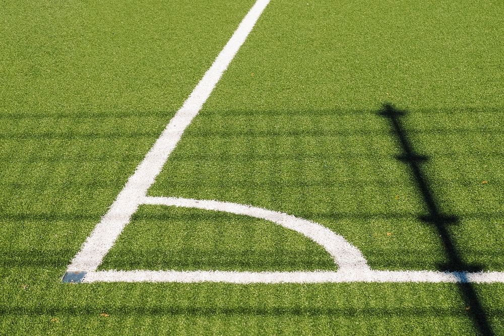 Corner of soccer field with white lines in an angle on turf. Original public domain image from Wikimedia Commons