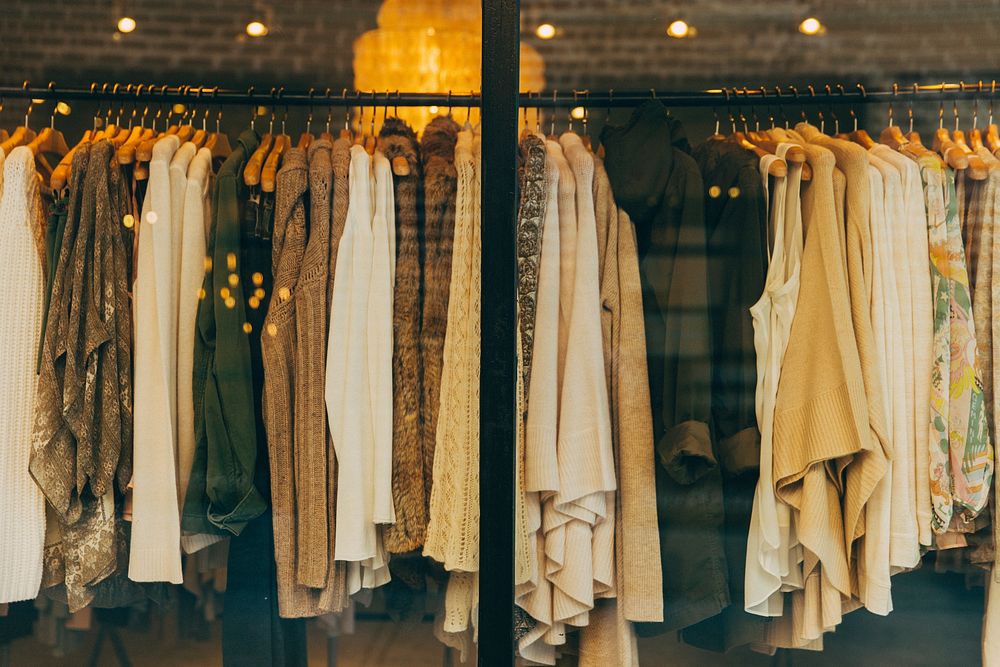Blouses, jackets and sweater on hangers in a store window. Original public domain image from Wikimedia Commons