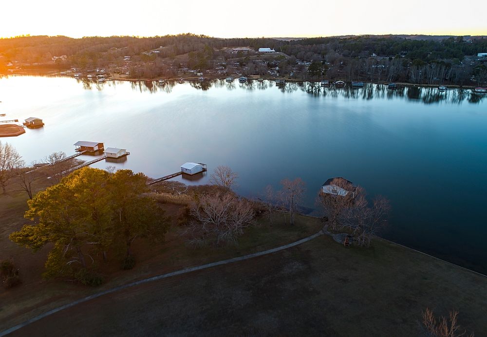 Aerial view shot with a drone of boathouses in Guntersville, Alabama during sunset. Original public domain image from…