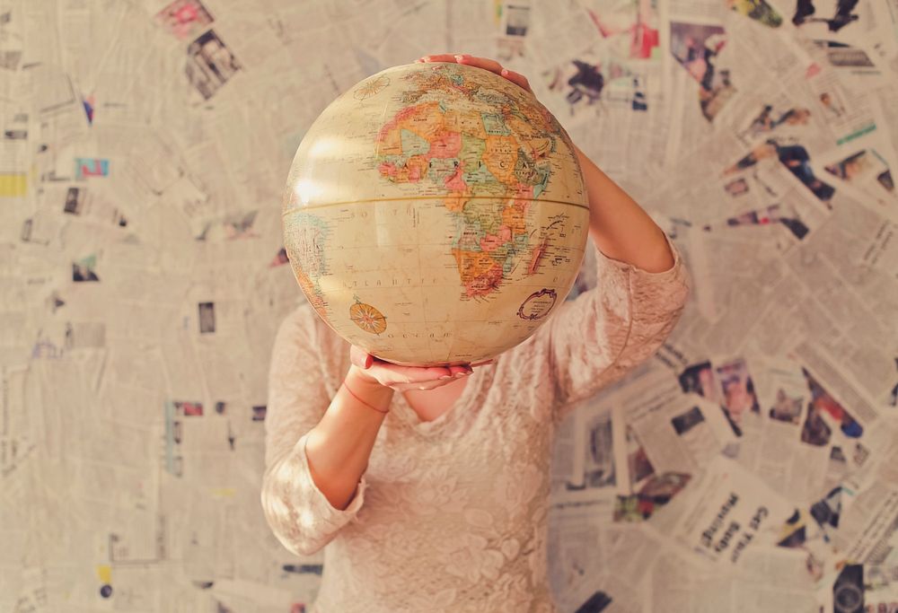 A person holding a world globe. Original public domain image from Wikimedia Commons