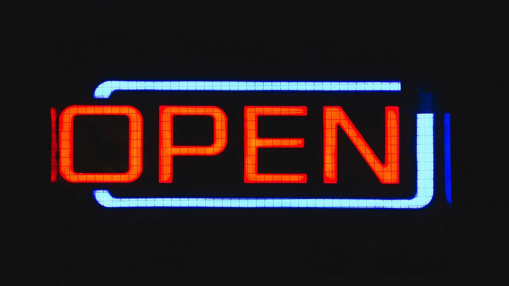 A bright red and blue neon reads “open”. Original public domain image from Wikimedia Commons