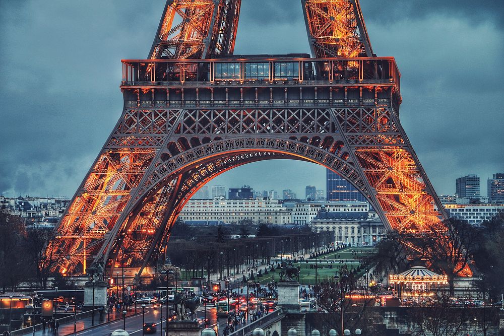 The landmark Eiffel Tower in Paris, France illuminated at night. Original public domain image from Wikimedia Commons