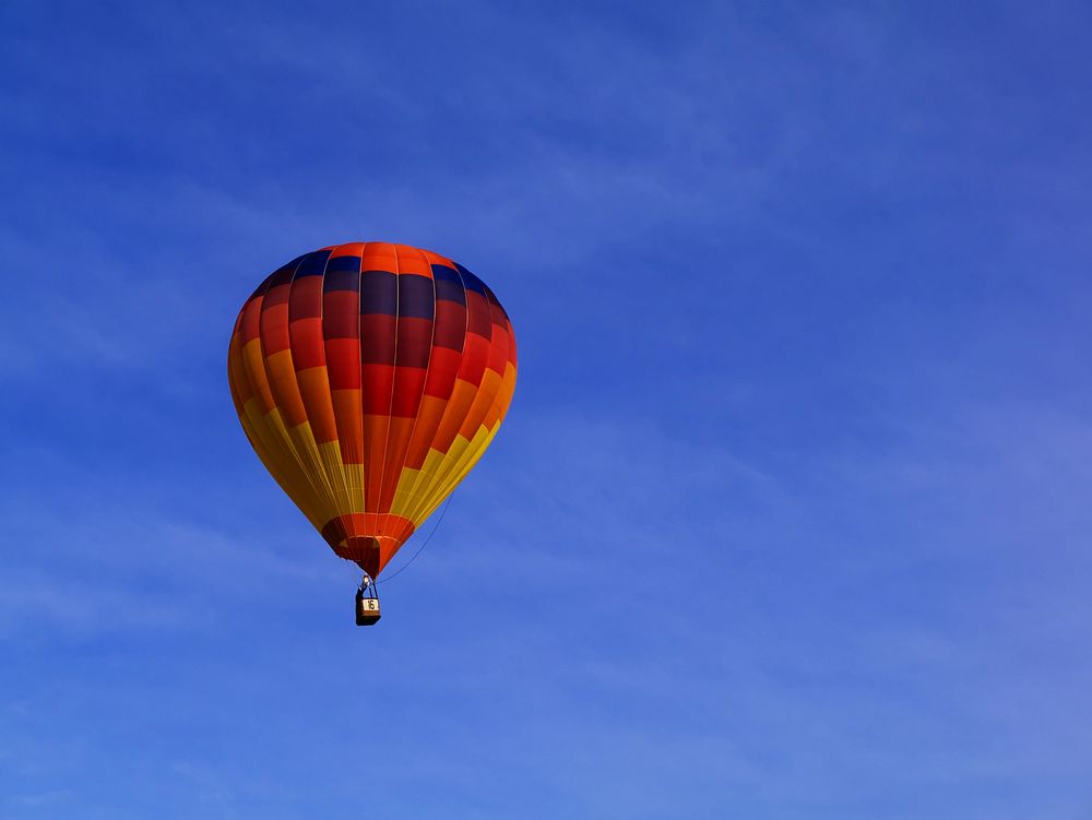 A colorful hot air balloon against the blue sky. Original public domain image from Wikimedia Commons