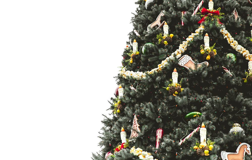 A festive, nicely decorated Christmas tree stands against a white background. Original public domain image from Wikimedia…