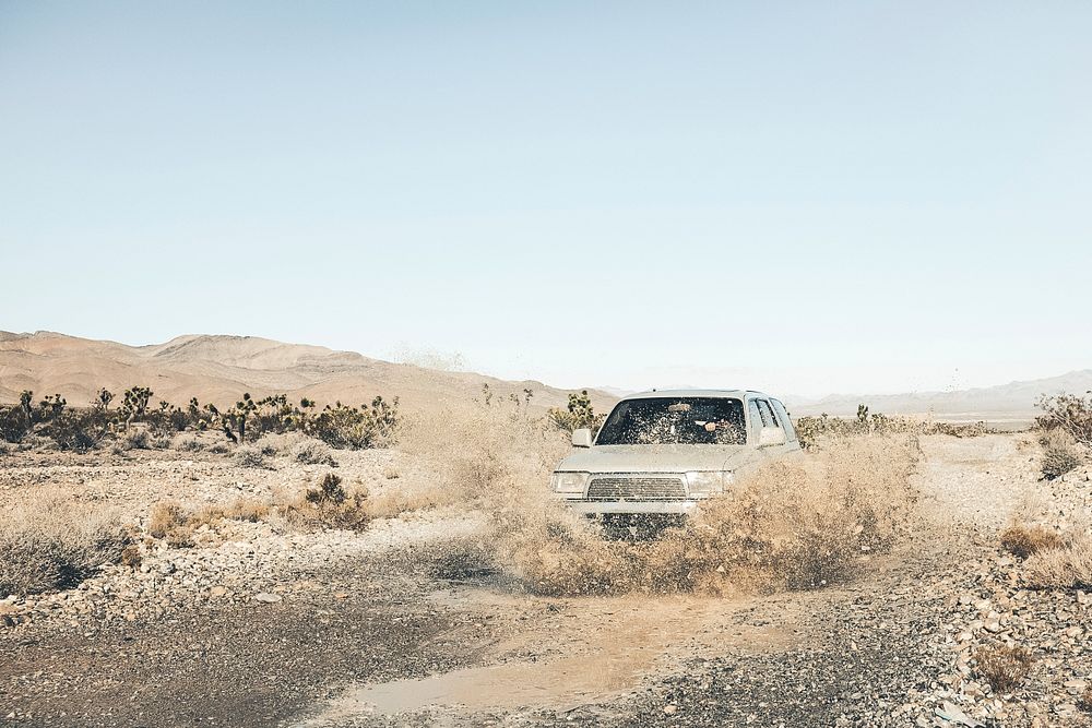 off-roader truck drives through dusty rural roads in the Mount Charleston desert. Original public domain image from…