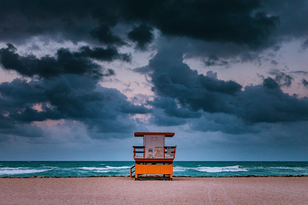 Lifeguard hut on the sand beach in Miami on a day with storm clouds. Original public domain image from Wikimedia Commons