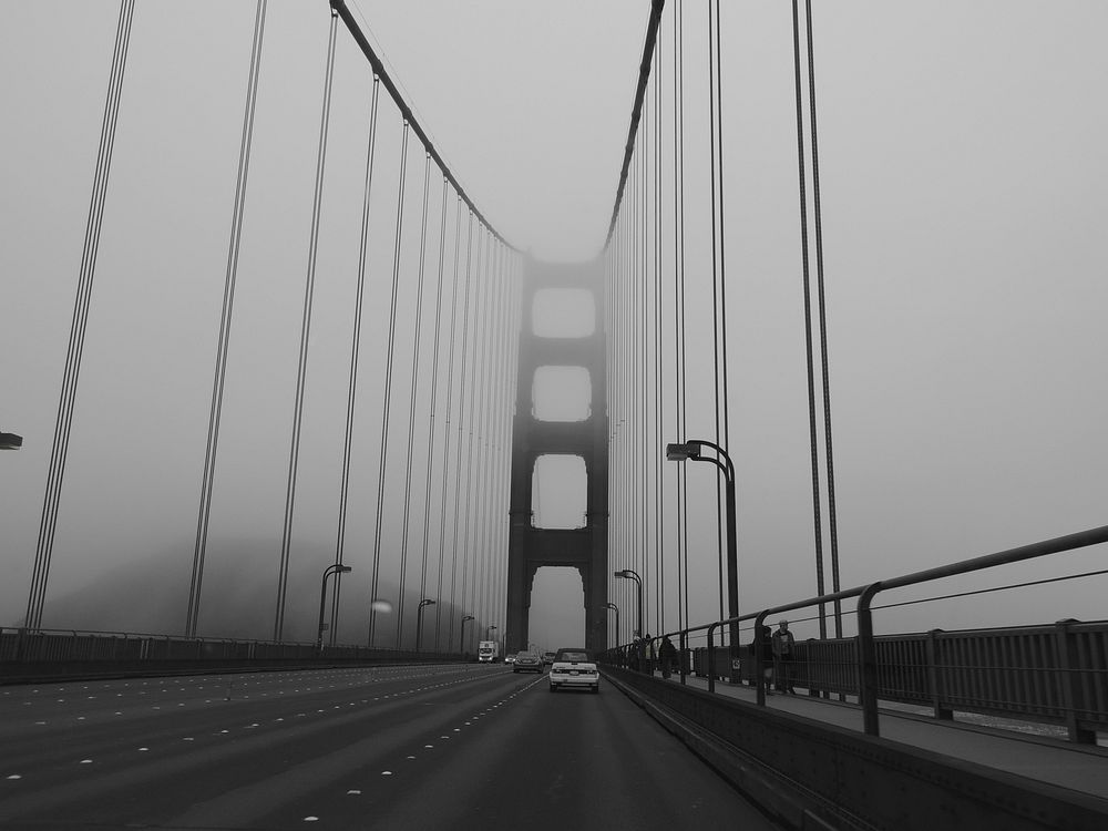 Driving the Golden Gate Bridge on a foggy grey day. Original public domain image from Wikimedia Commons