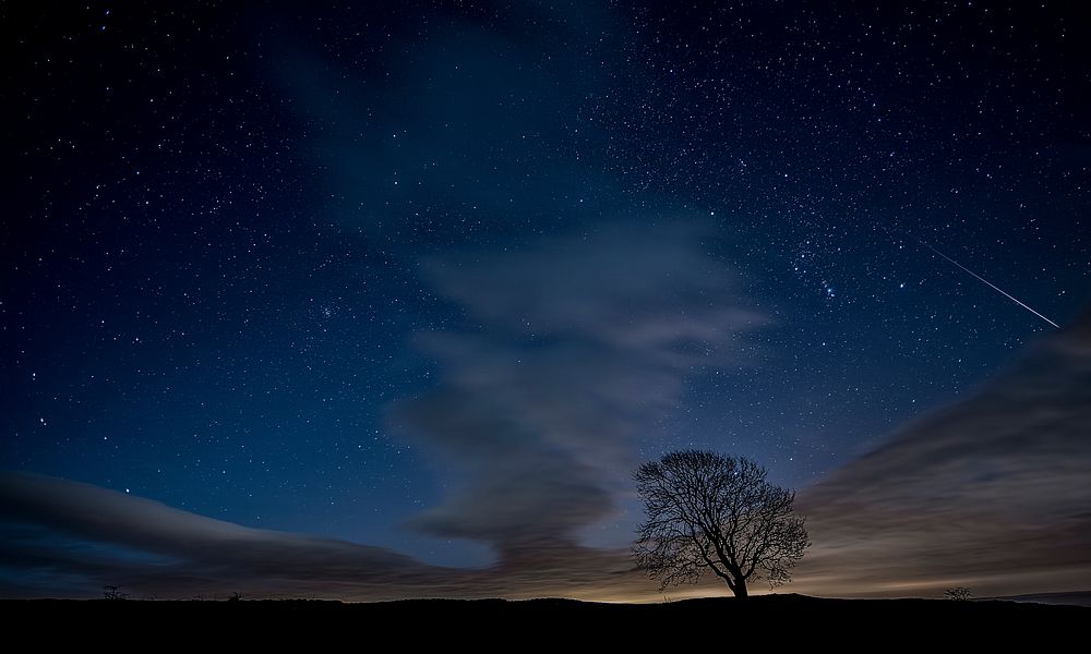 A night-time background featuring a blue sky with gusty dark clouds in Malham Cove. Original public domain image from…