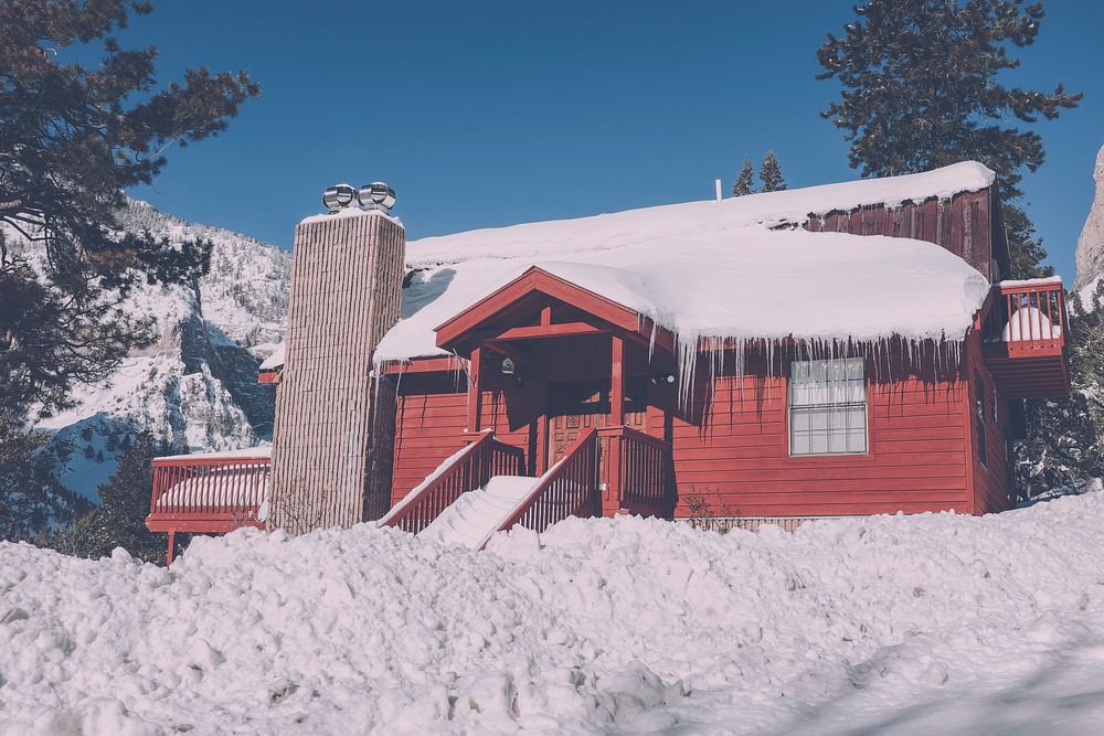 A large red cabin sitting in the middle of a forest around Mount Charleston, Nevada. Original public domain image from…