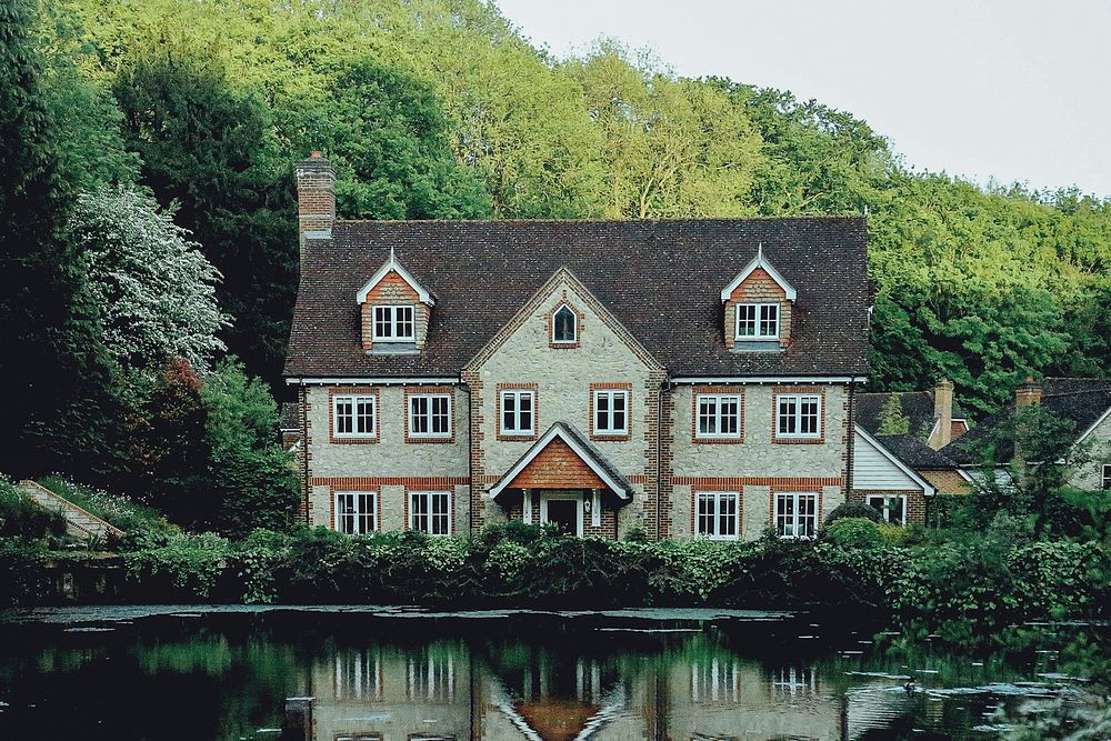 Elegant house in London next to a pond and in front of a forested hill. Original public domain image from Wikimedia Commons