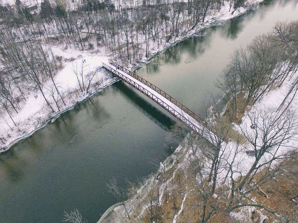Aerial view of a bridge crossing a river surrounded by a winter landscape. Original public domain image from Wikimedia…