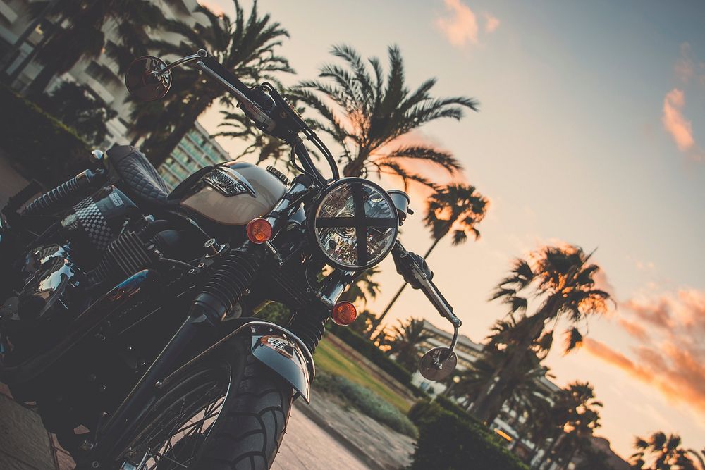 Black motorbike with sunset in Majorca, Spain. Original public domain image from Wikimedia Commons