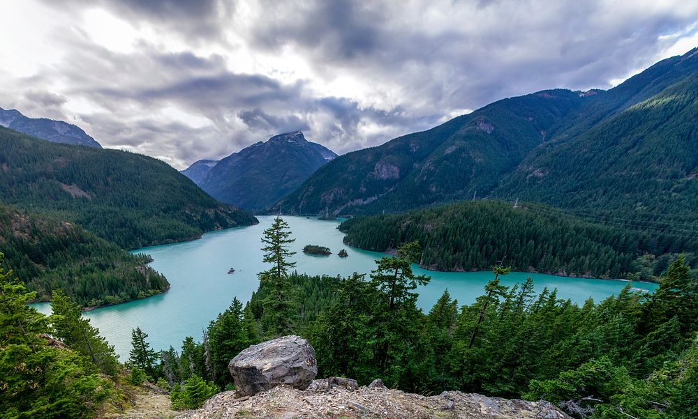 View from a rocky ledge on a beautiful azure lake in the mountains in Diablo Lake, United States. Original public domain…