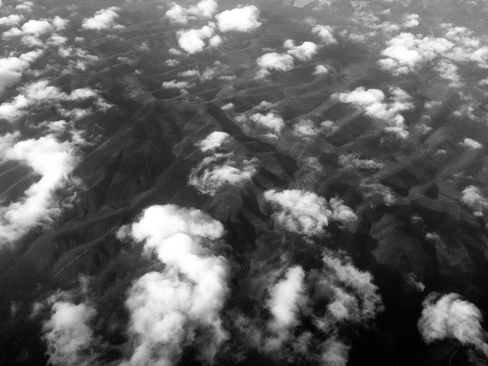 Black and white drone shot of clouds over mountain range in Nuevo Leon. Original public domain image from Wikimedia Commons