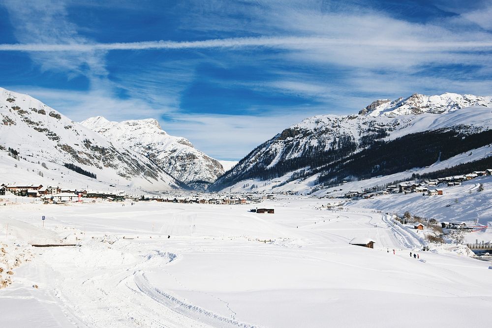 A mountain village under a thick snow blanket in Livigno Alps. Original public domain image from Wikimedia Commons