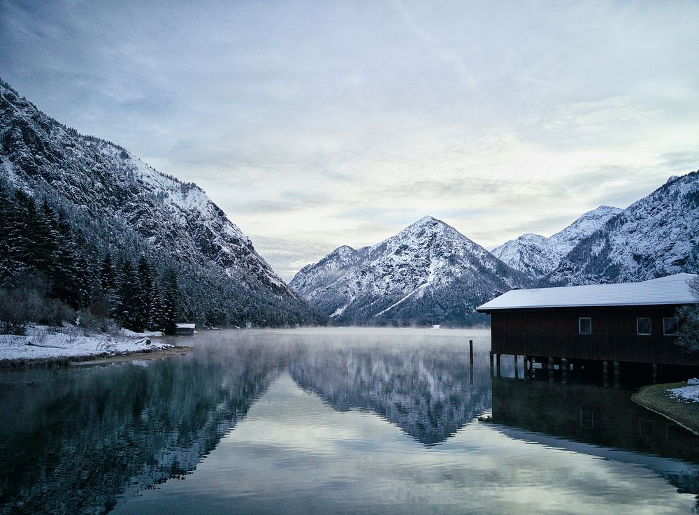 A cabin on a misty mountain lake in Heiterwang in the winter. Original public domain image from Wikimedia Commons