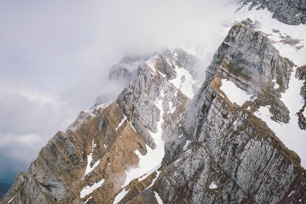 A high view of a steep rocky face of a tall mountain. Original public domain image from Wikimedia Commons