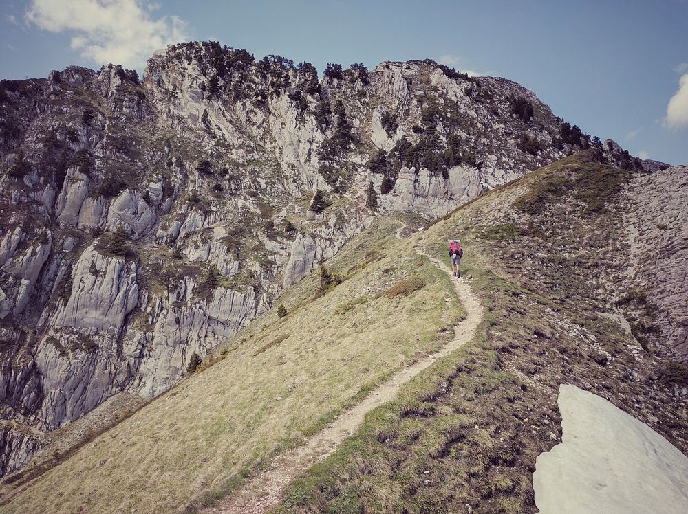 A person hiking up a steep trail along the side of a mountain in Grenoble. Original public domain image from Wikimedia…