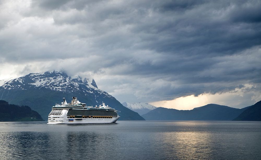 A cruise ship on a mountain lake with heavy clouds above. Original public domain image from Wikimedia Commons