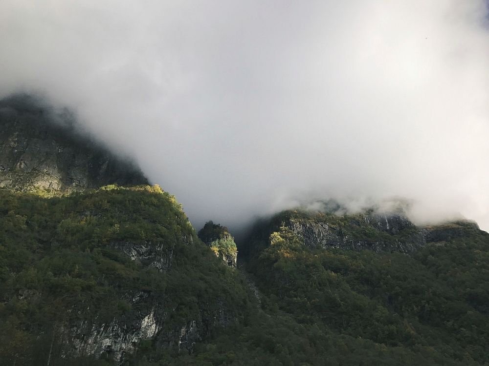 Grassy mountains shrouded in fog in Norway. Original public domain image from Wikimedia Commons