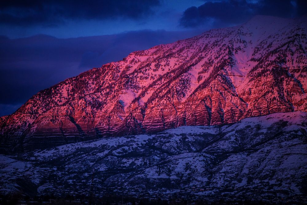 Red-hued sunlight falls on a snowy mountain slope in Provo during sunset. Original public domain image from Wikimedia Commons