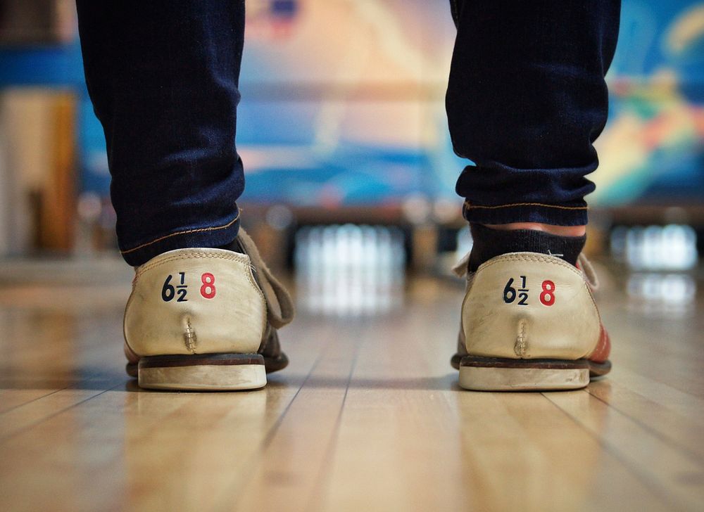 Person standing on bowling court. Original public domain image from Wikimedia Commons