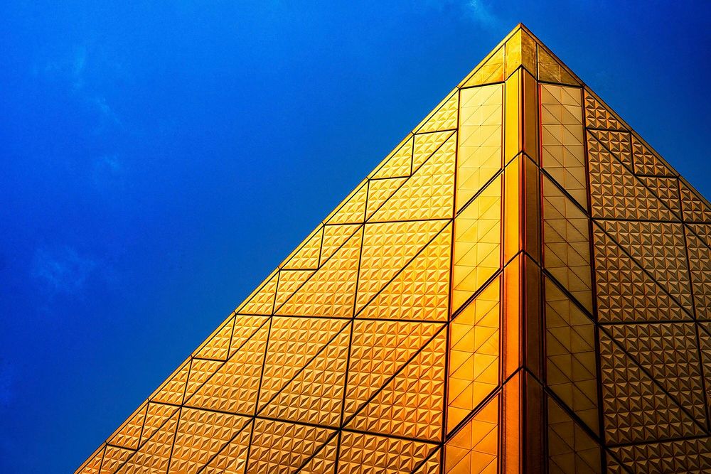 The edge of a golden facade with tiles in geometric shapes. Original public domain image from Wikimedia Commons