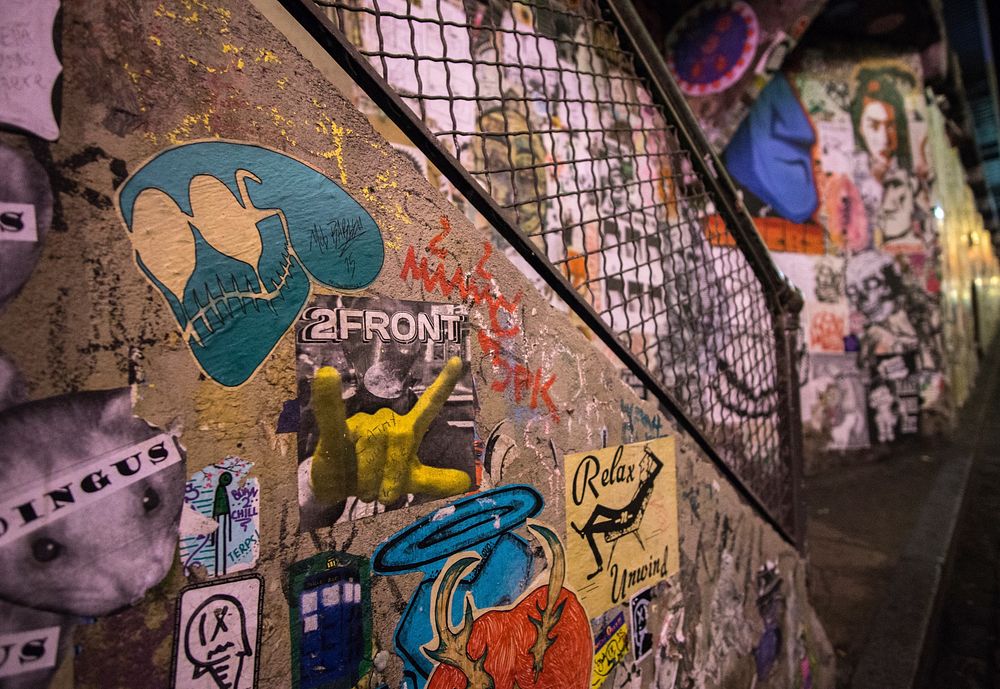 Stickers and graffiti on a staircase in an underpass in Post Alley. Original public domain image from Wikimedia Commons