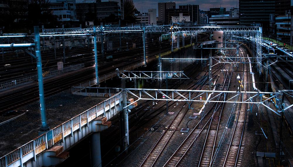 Metal beams and rail over an empty train station at night. Original public domain image from Wikimedia Commons