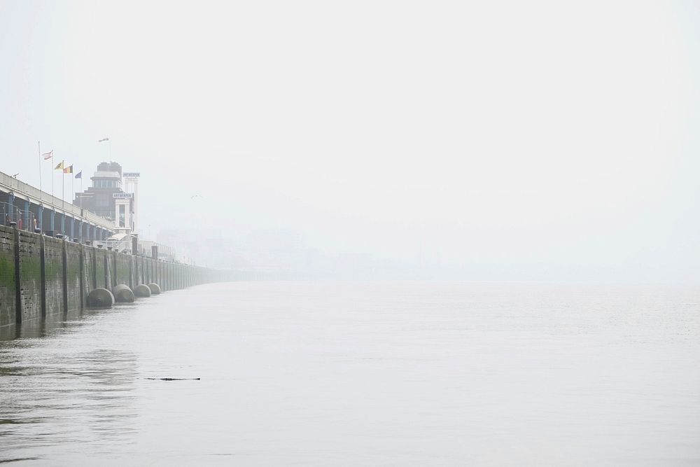 Wall by the seaside on a foggy morning in Antwerp. Original public domain image from Wikimedia Commons