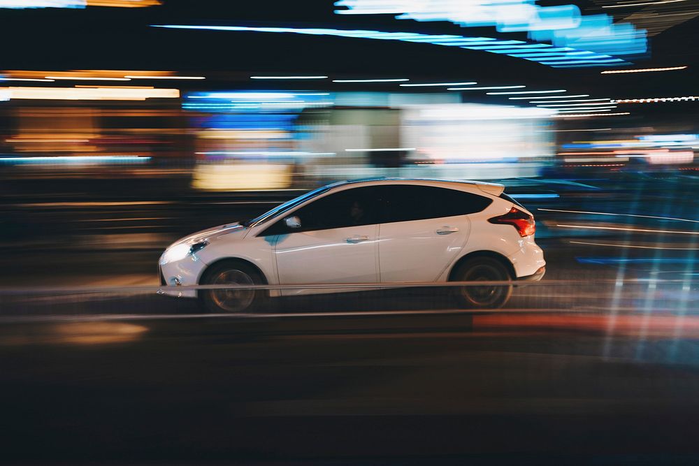 A long exposure of a car driving in Wencheng at night with lights around it. Original public domain image from Wikimedia…