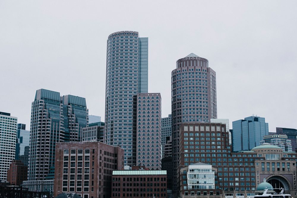 Boston city skyscrapers against a gray, overcast sky. Original public domain image from Wikimedia Commons