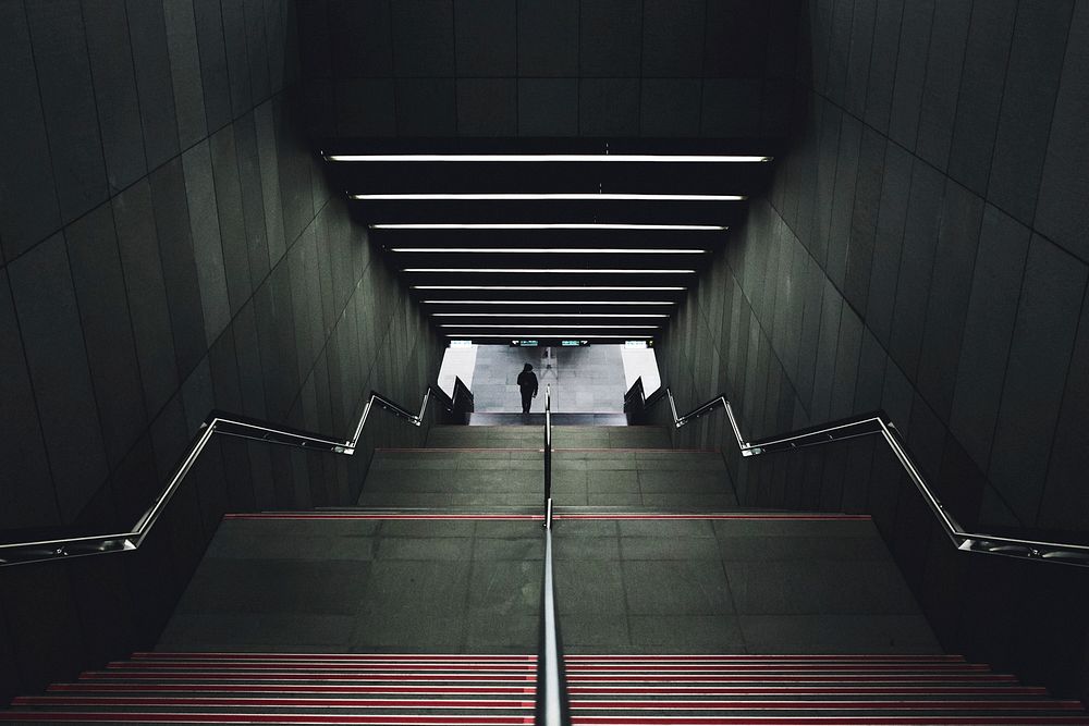 Looking down a symmetrical staircase in an urban transportation station. Original public domain image from Wikimedia Commons