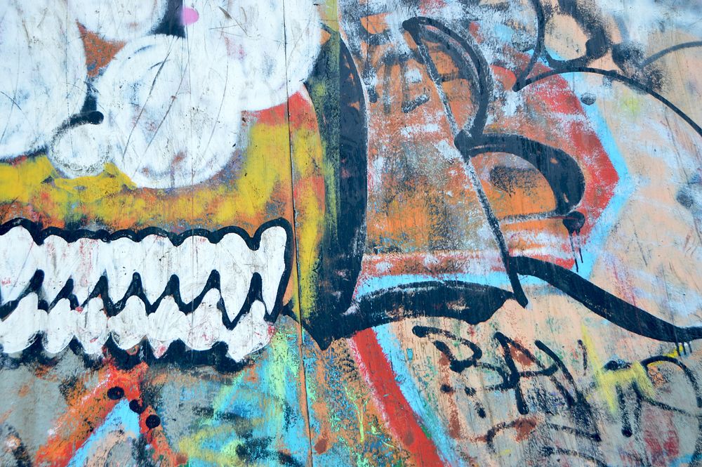 Colorful urban spray painted street art graffiti design on wall weathered by urban decay, N8. Original public domain image…