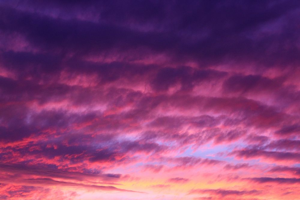 The sunset turns the cloudy sky purple and pink at Bondi Beach. Original public domain image from Wikimedia Commons