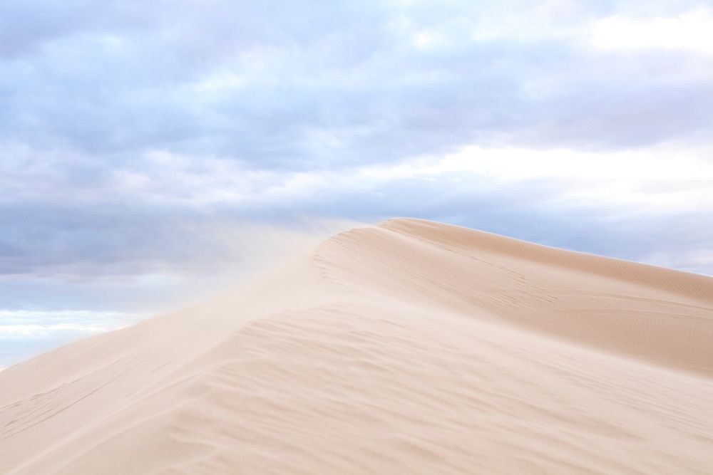 While rolling sand dunes in the desert of Glamis. Original public domain image from Wikimedia Commons