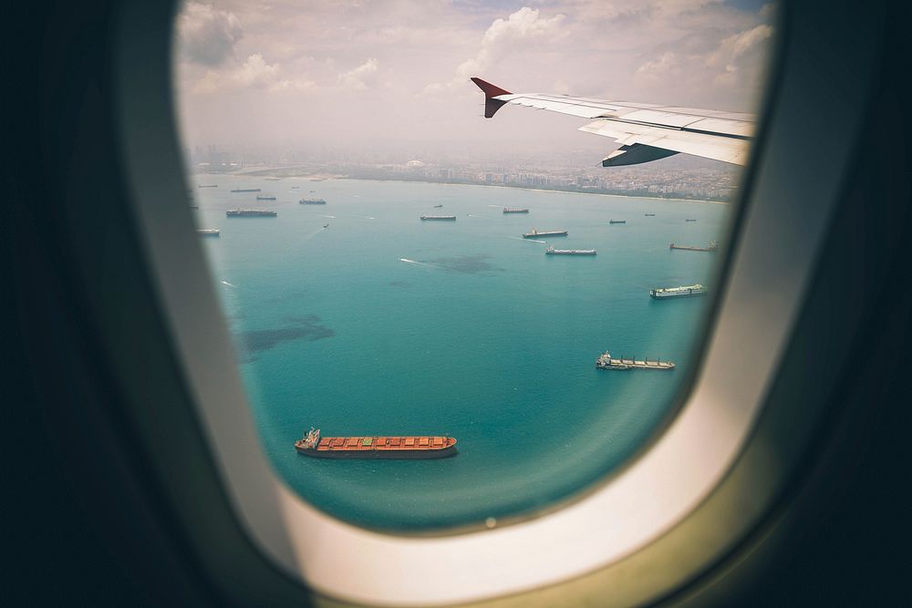 Airplane window with sea view. Original public domain image from Wikimedia Commons